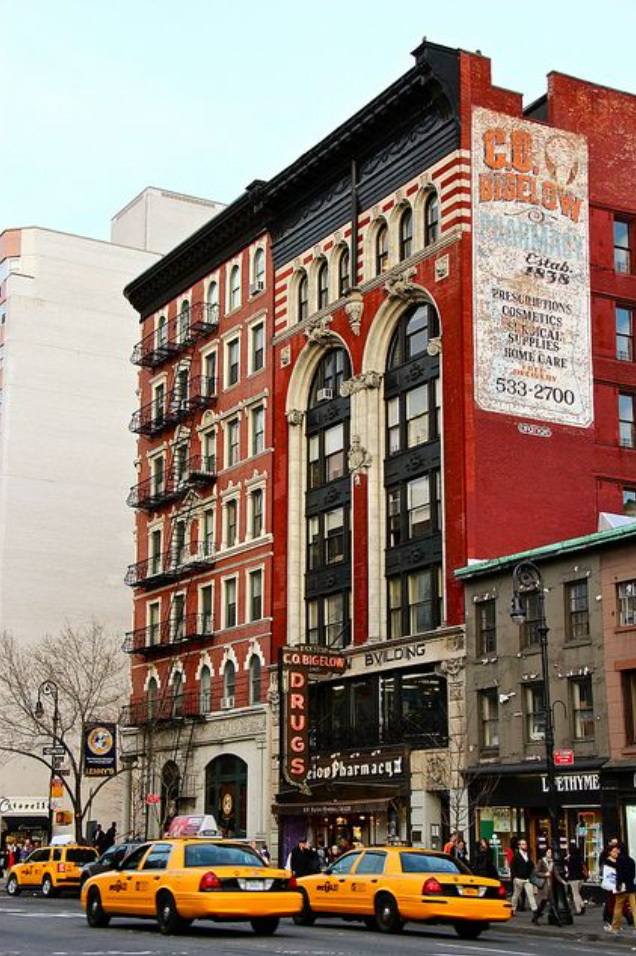 C.O. Bigelow building in NY with Taxis driving past. Now carrying Meggo Sweets